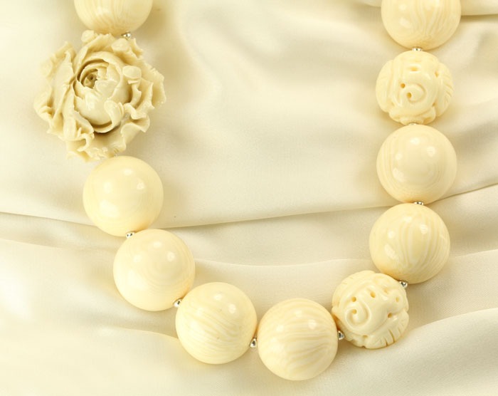 Carved Bone Necklace with Coral Flower