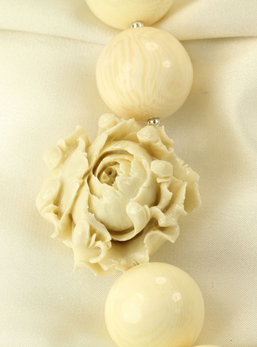 Carved Bone Necklace with Coral Flower