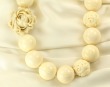 Carved Bone Necklace with Coral Flower